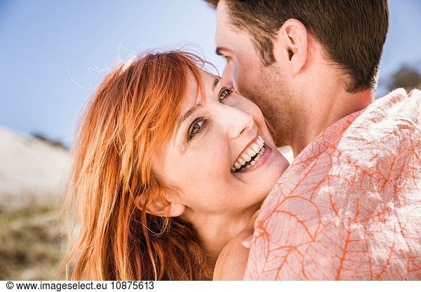 Couple hugging  outdoors  smiling  close-up