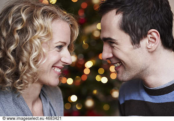 Couple in front of xmas tree