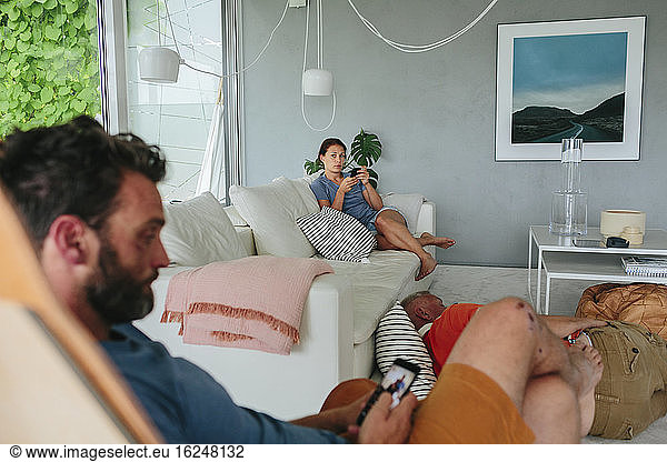 Couple in living room using cell phones