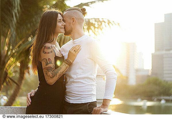 couple in love at sunset in the sunshine in tropical metropolis