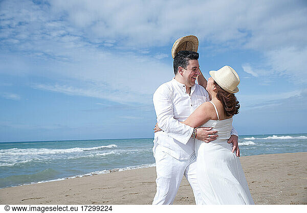 Couple in love  Hispanic man with Latin woman  walking on the beach.