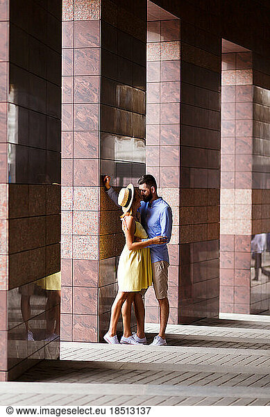 couple in love is tenderly embracing in the summer in city