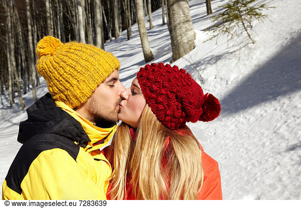 Couple kissing in snow