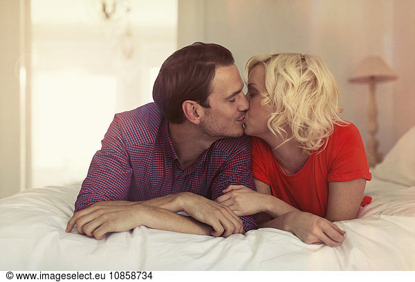 Couple kissing on bed