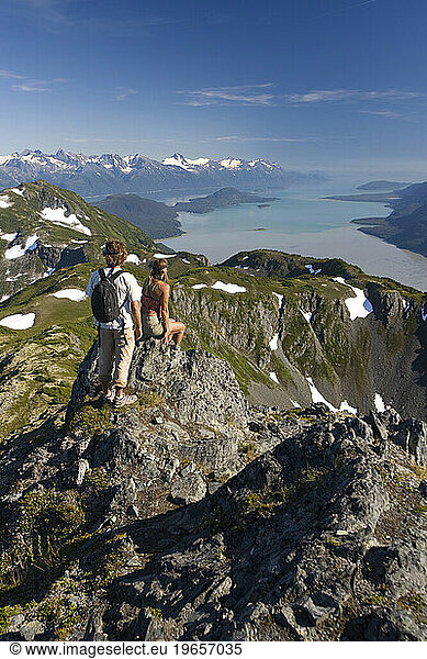 Couple looking at view of mountains and ocean near Haines  Alaska.