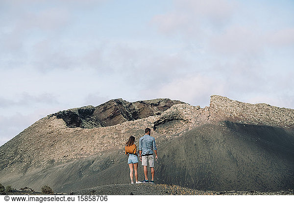 Couple looking the Volcano Cuervo in Lanzarote  Timanfaya.