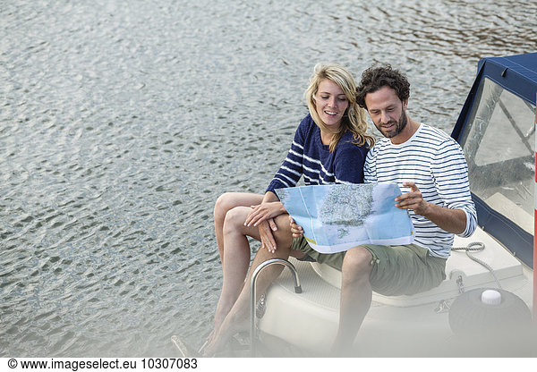 Couple on boat looking at map