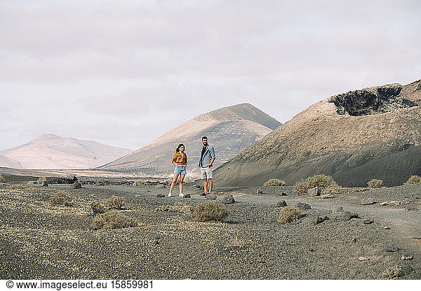 Couple posing outside the Volcano Cuervo in Lanzarote  Timanfaya.