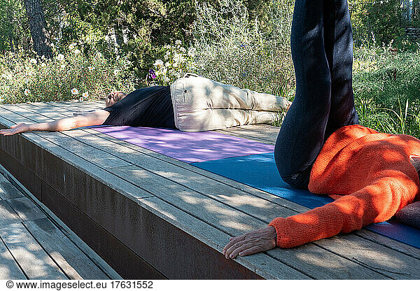Couple practicing yoga outdoors.
