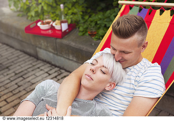 Couple relaxing on hammock