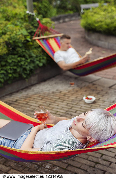 Couple relaxing on hammocks