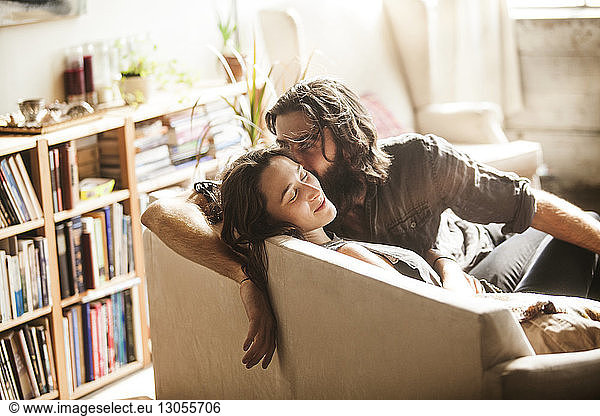 Couple relaxing on sofa at home