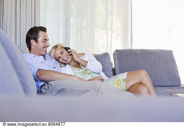 Couple relaxing on sofa together