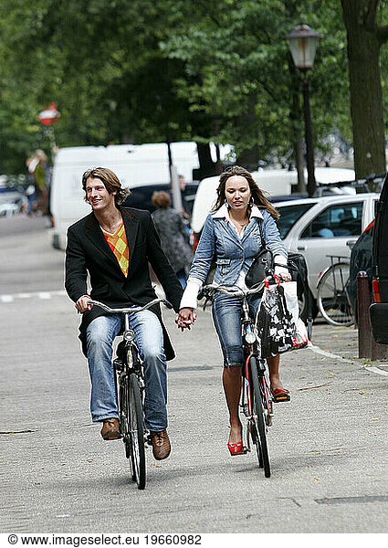 couple riding bicycle  Amsterdam  Holland.