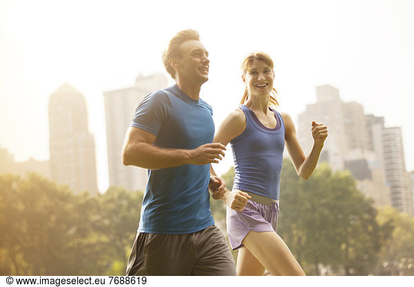 Couple running in urban park