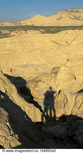 Couple shadows over sunny dunes in a desert