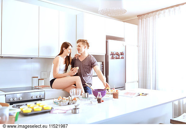 Couple sharing food in kitchen