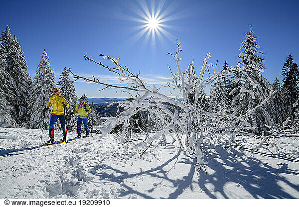 Couple skiing together on sunny day