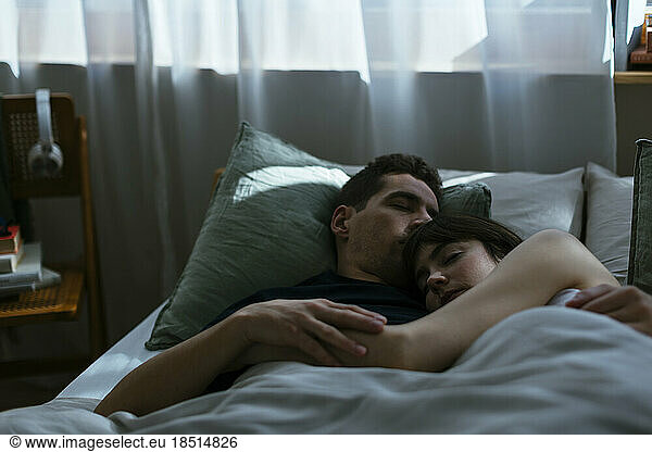 Couple sleeping in bedroom together