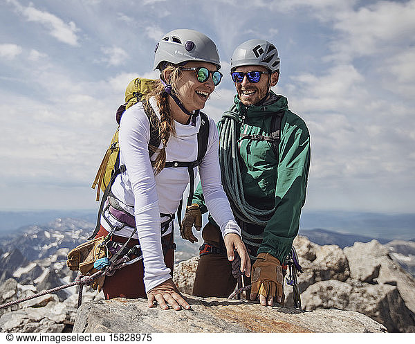 Couple smiles with joy after reaching summit of Grand Teton  Wyoming