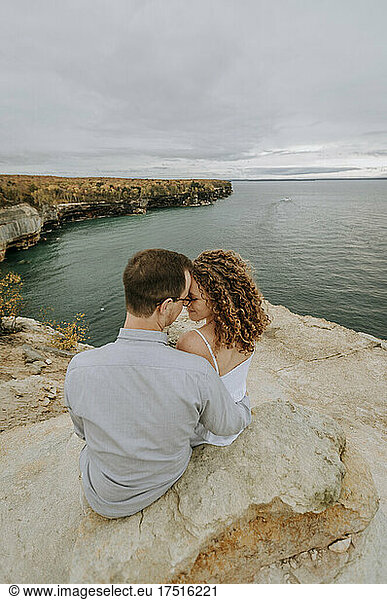Couple snuggles on cliffs of Pictured Rocks Lakeshore  Michigan