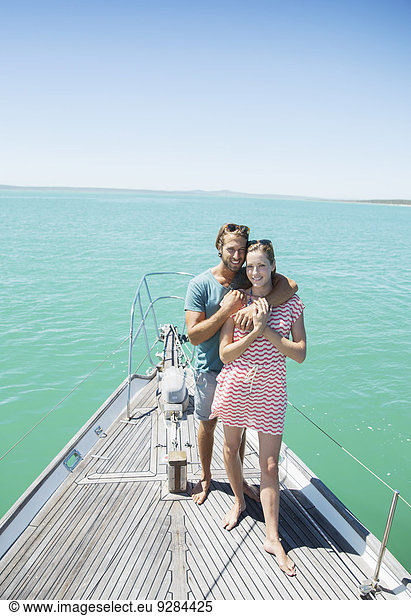 Couple standing on boat together