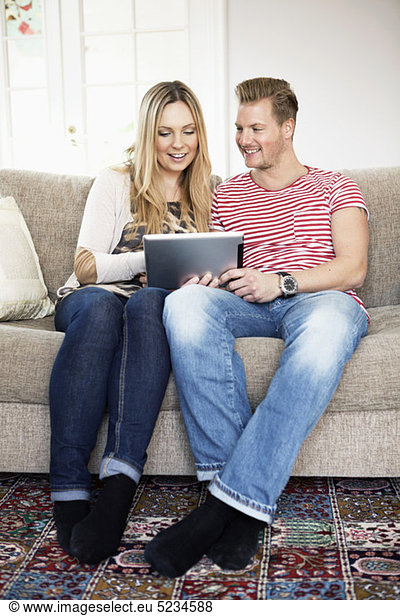 Couple surfing in sofa