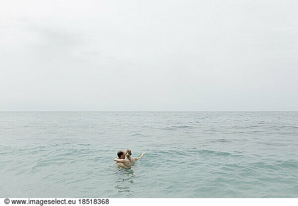 Couple swimming together in sea