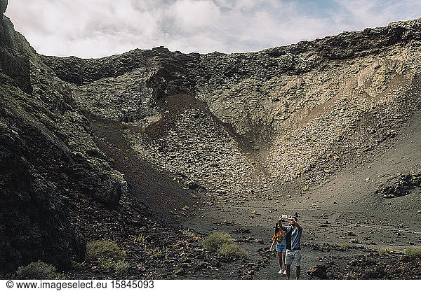 Couple taking a selfie inside of the Volcano Cuervo in Lanzarote.