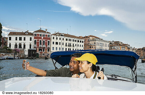 couple taking selfie on Taxi boat in Venice