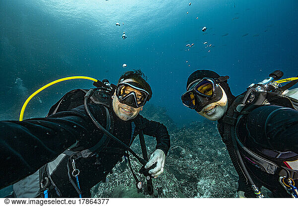 couple taking selfie under water at the Andaman Sea in Thailand