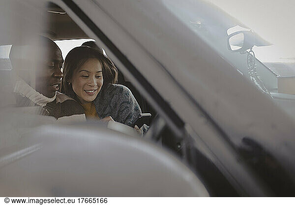 Couple using smart phone in car