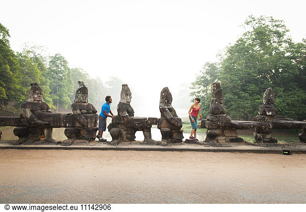 Couple visiting ancient temple  Angkor  Siem Reap  Cambodia