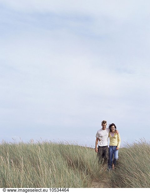 Couple walking in field
