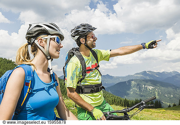 Couple with mountain bikes in the mountains  Achenkirch  Austria