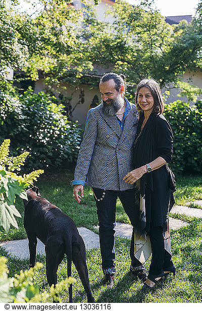 Couple with pet dog in garden