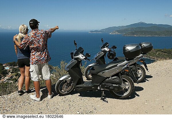Couple with scooter looking at the sea  Elba  Tuscany  Italy  Europe