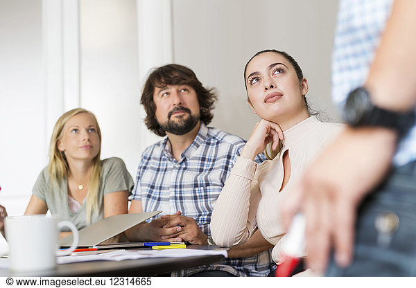 Coworkers listening during business meeting