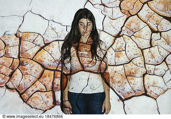 Cracked land projected on woman