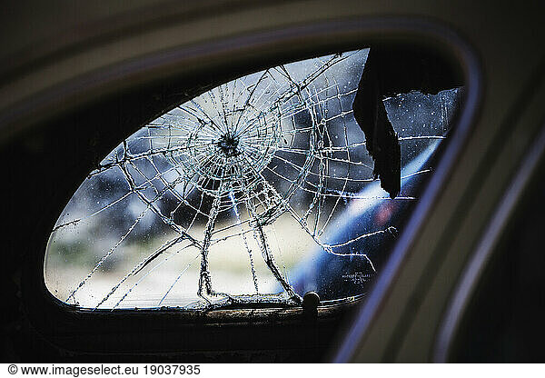 Cracked rear window of old car  Mono County  California  USA