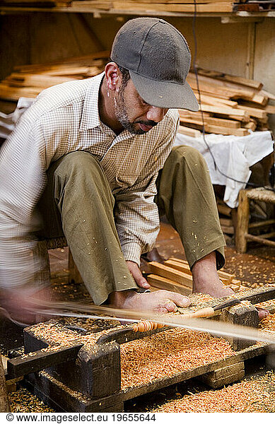 Crafts man at the Medina (old Town) making wooden souvenirs. Marrakesh  Morocco.