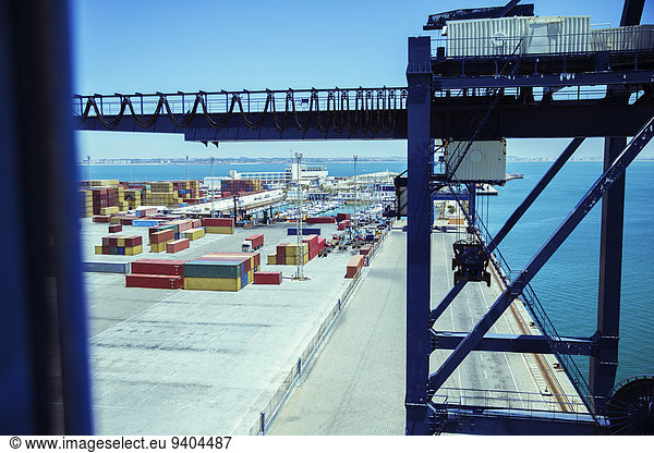 Crane and cargo containers at waterfront