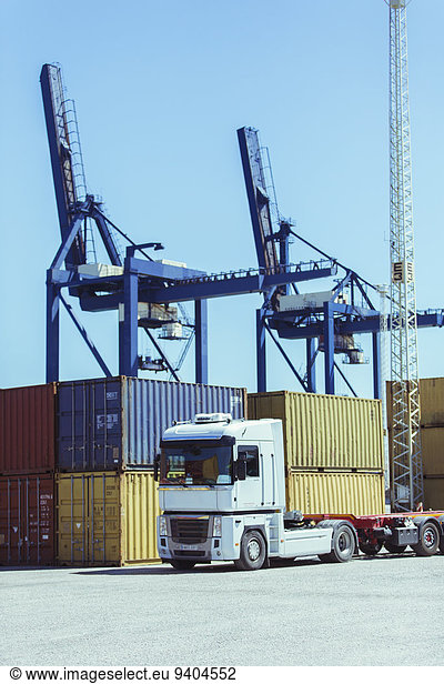 Cranes over cargo containers and truck