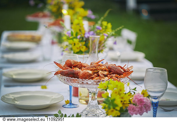 Crayfish in glass bowl on elegant garden party table