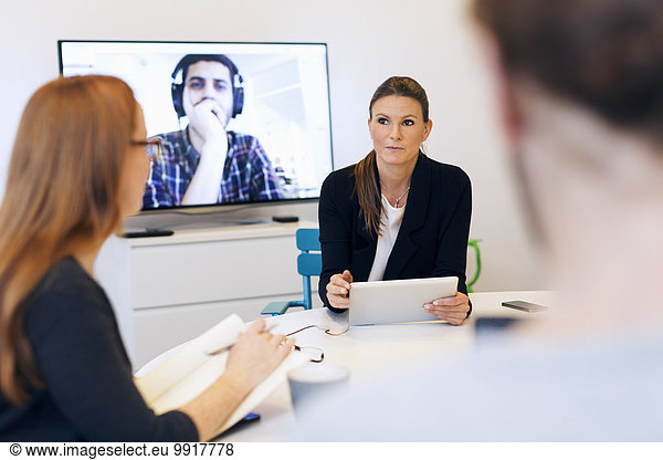 Creative business people discussing during video conference in office
