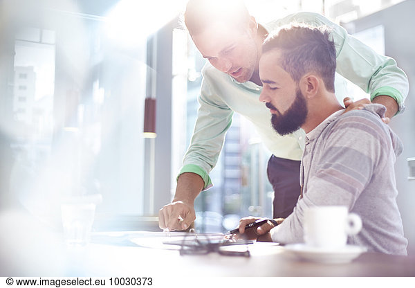 Creative businessmen reviewing paperwork