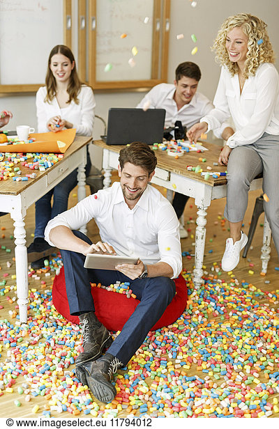 Creative professionals meeting in office surrounded by colorful polystyrene parts