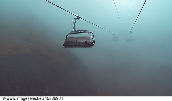 Creepy cable car in dark fog
