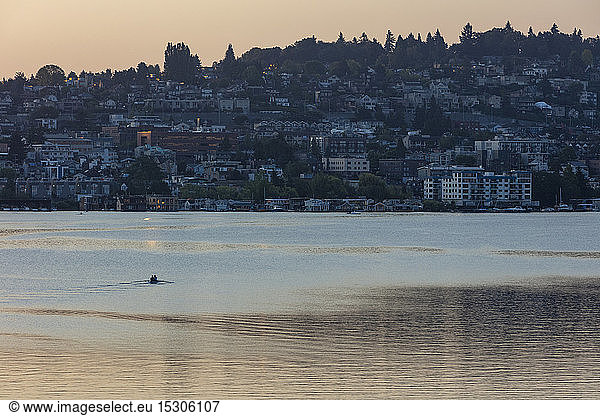 Crew racers rowing double scull boat on Lake Union at dawn  Seattle  Washington  USA.