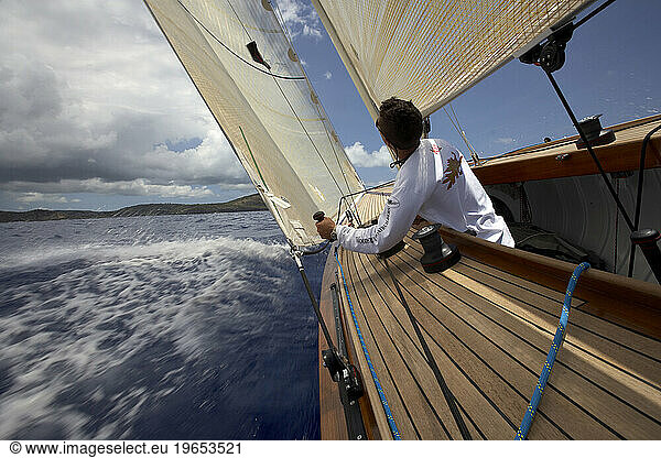 Crew trims the jib with precision on a sailing yacht.